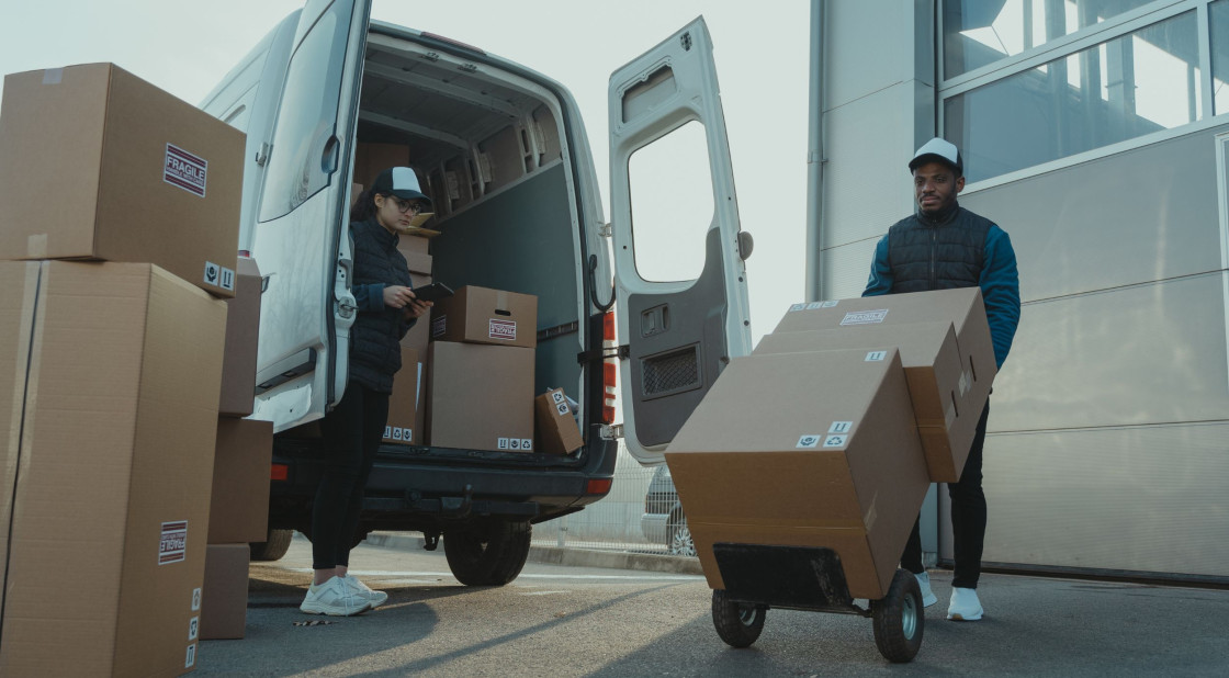 Delivery van unloading Mexican food boxes, showcasing organized logistics and teamwork.