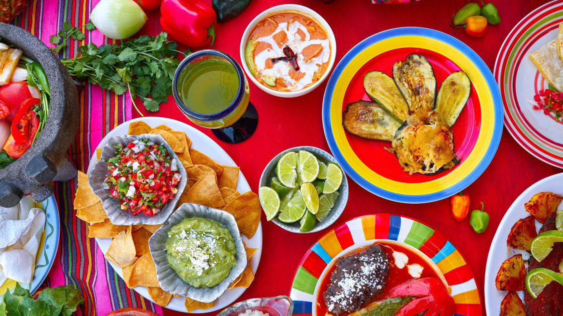 Vibrant Mexican feast featuring delicious dishes like guacamole, enchiladas, and fresh salsa.
